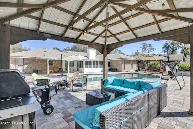 view of patio with a fenced in pool, a gazebo, outdoor lounge area, and a sunroom