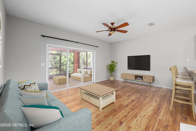 living room with hardwood / wood-style flooring and ceiling fan