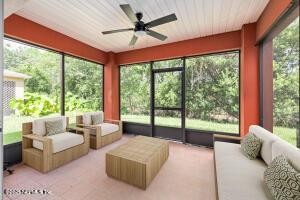 sunroom / solarium featuring plenty of natural light and ceiling fan