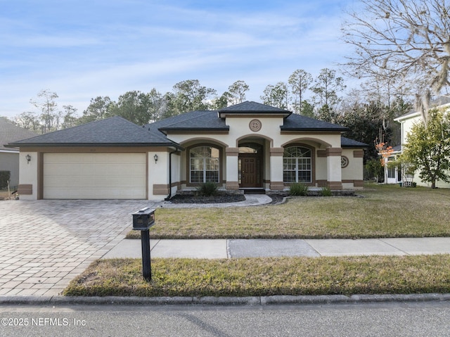 view of front of home with a garage and a front lawn