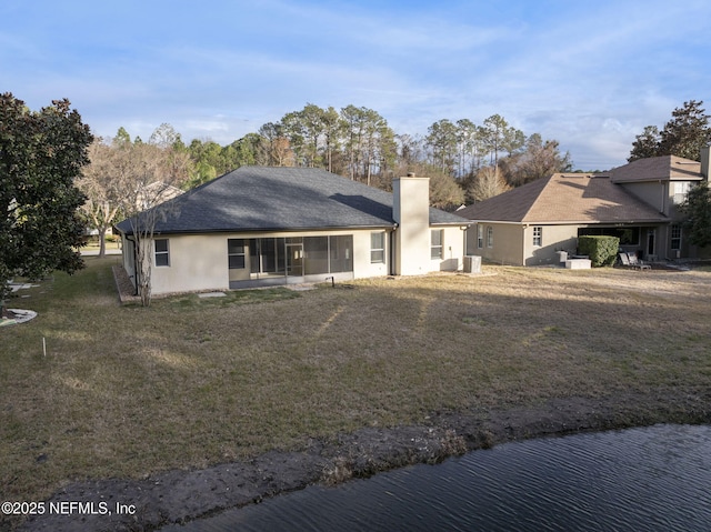 rear view of house with a yard