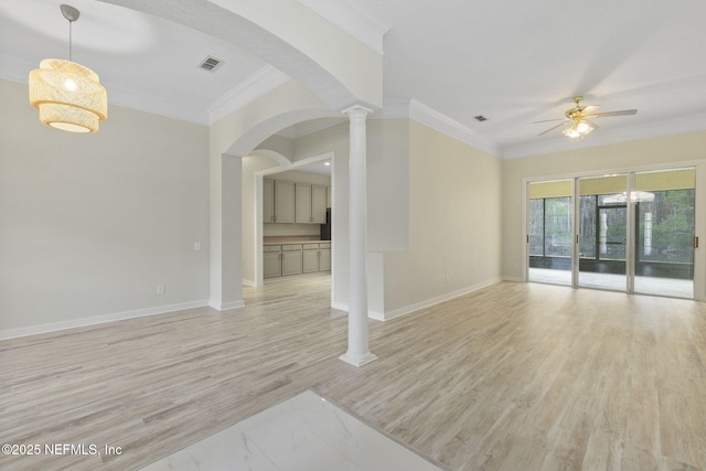 spare room with ornate columns, crown molding, ceiling fan, and light hardwood / wood-style flooring