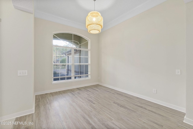 unfurnished room featuring crown molding and hardwood / wood-style floors