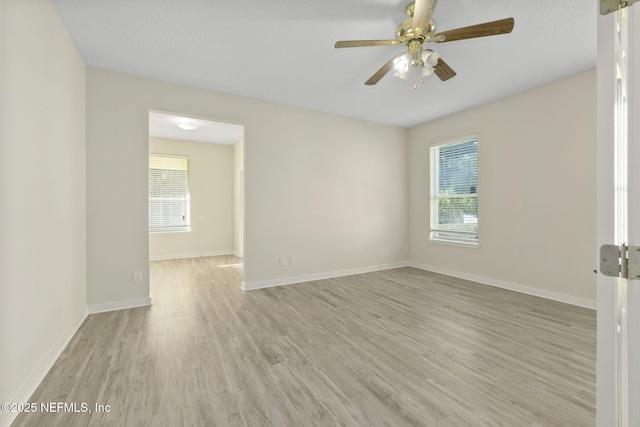 spare room featuring ceiling fan and light hardwood / wood-style floors