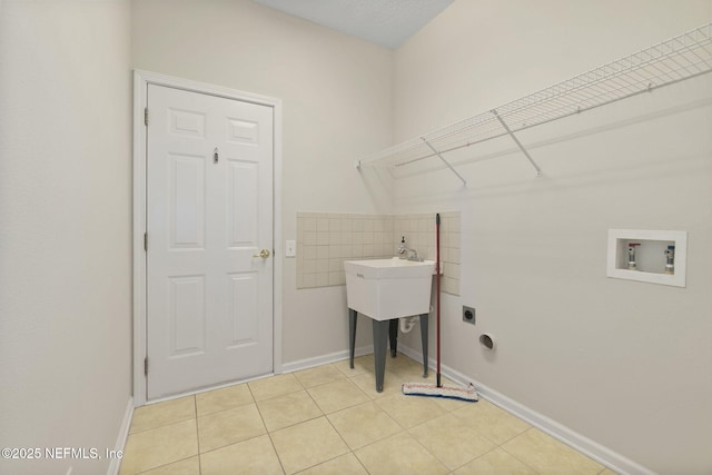 clothes washing area with washer hookup, hookup for an electric dryer, and light tile patterned floors