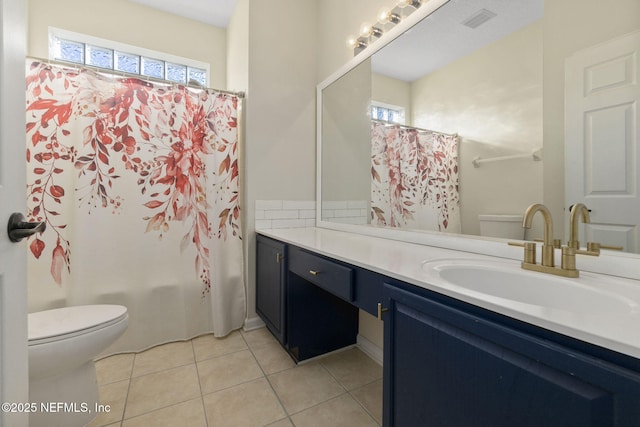 full bathroom with tile patterned flooring, vanity, a healthy amount of sunlight, and toilet