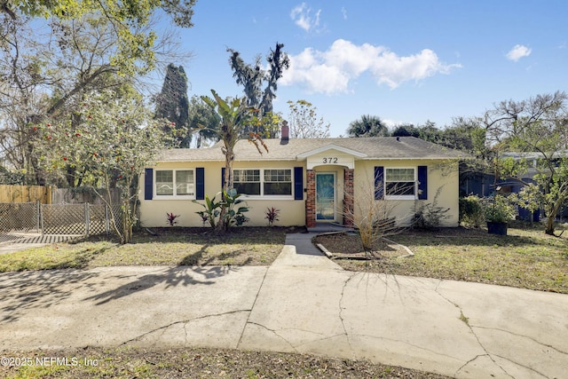 ranch-style home with a front lawn