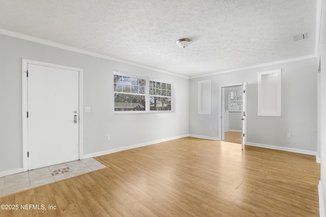 foyer featuring crown molding, a textured ceiling, and light hardwood / wood-style flooring