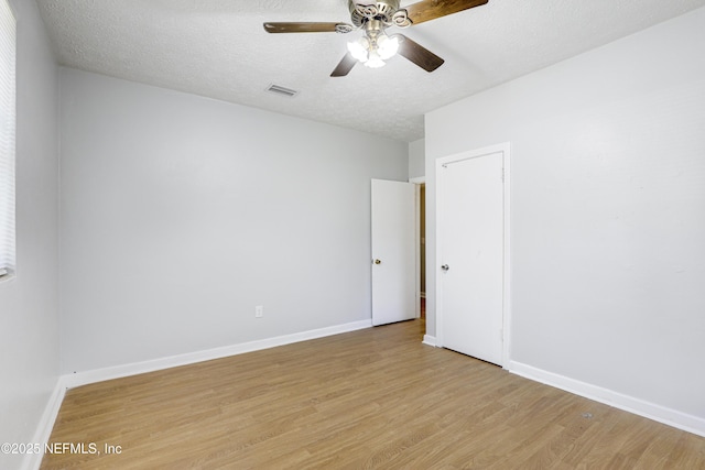 unfurnished room featuring ceiling fan, a textured ceiling, and light hardwood / wood-style floors