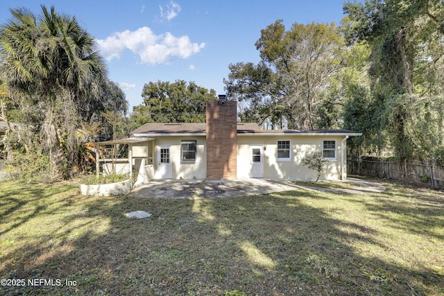 back of house featuring a yard and a patio