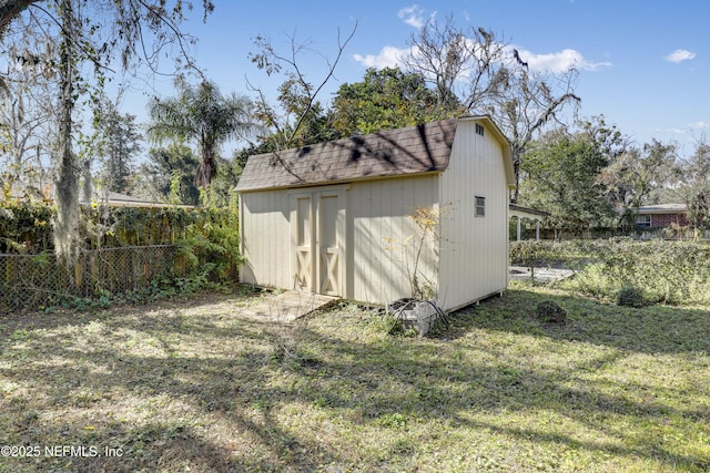 view of outbuilding with a yard