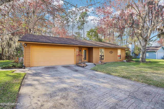 single story home featuring a garage, driveway, and a front lawn