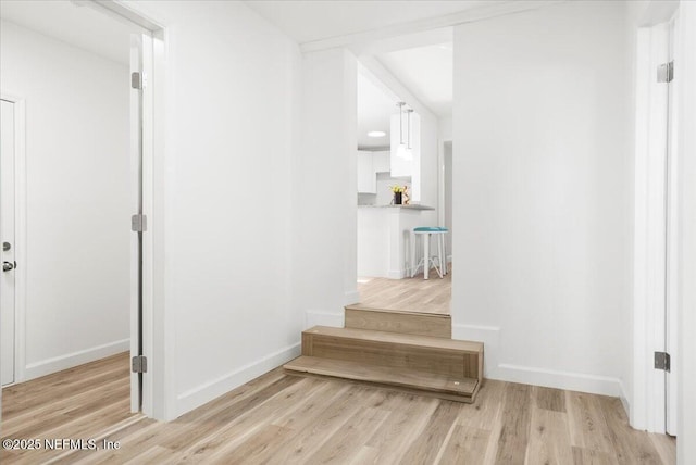 hallway with light hardwood / wood-style flooring