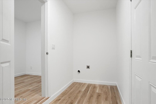 laundry room with light hardwood / wood-style flooring and electric dryer hookup