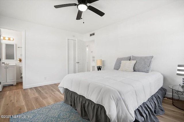 bedroom featuring sink, ensuite bath, light hardwood / wood-style floors, and ceiling fan