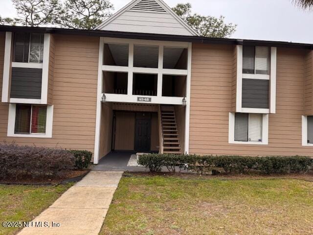 view of exterior entry featuring a yard