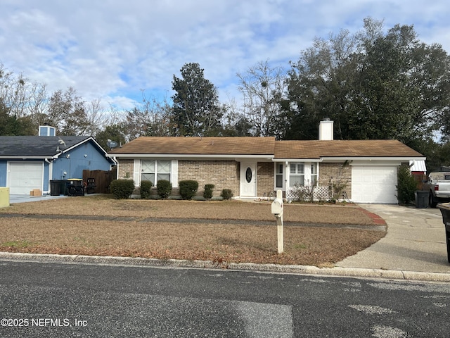 ranch-style home with a garage and a front lawn