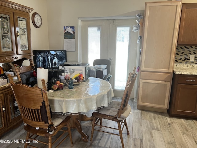 dining space featuring light hardwood / wood-style floors and french doors