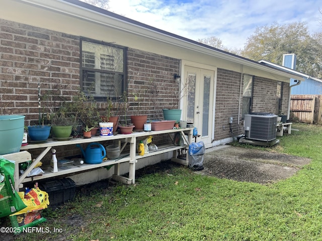 exterior space featuring a yard and central air condition unit