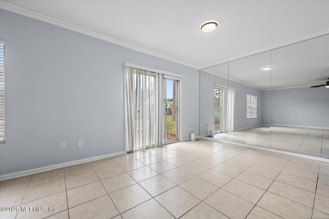 tiled empty room featuring crown molding and ceiling fan