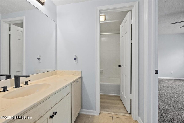 bathroom featuring tile patterned floors, vanity, tub / shower combination, and a textured ceiling