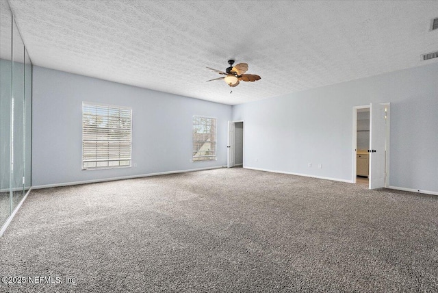 carpeted empty room with a textured ceiling and ceiling fan