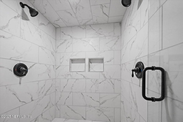 bathroom with tiled shower