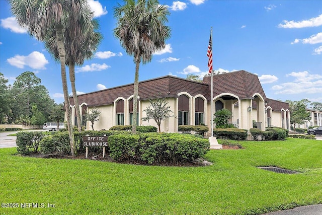 mediterranean / spanish-style home with a front yard