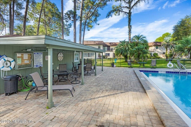 view of swimming pool with a patio and ceiling fan