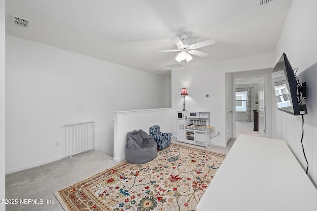 sitting room featuring ceiling fan and light colored carpet