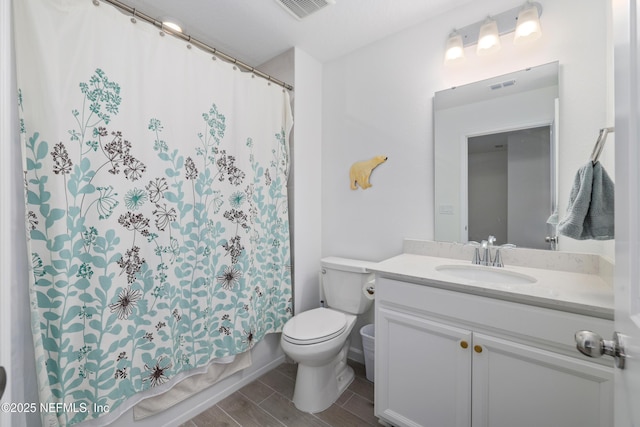 full bathroom featuring vanity, shower / tub combo, and toilet