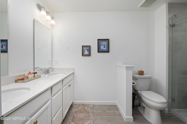 bathroom featuring walk in shower, vanity, and toilet