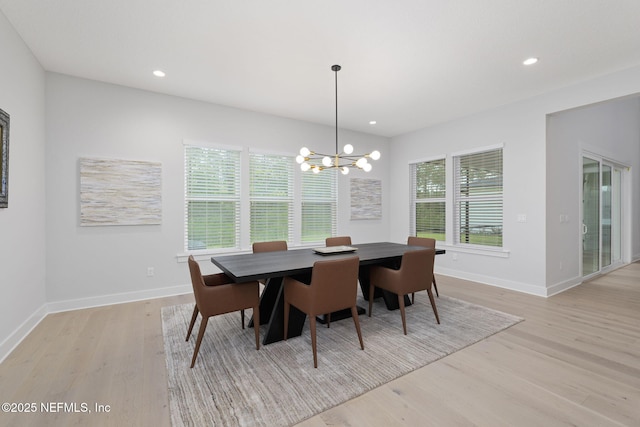 dining area featuring a chandelier and light wood-type flooring