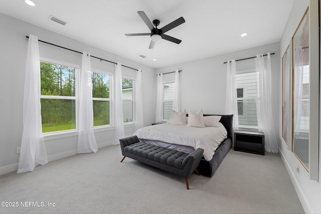 bedroom featuring light colored carpet and ceiling fan