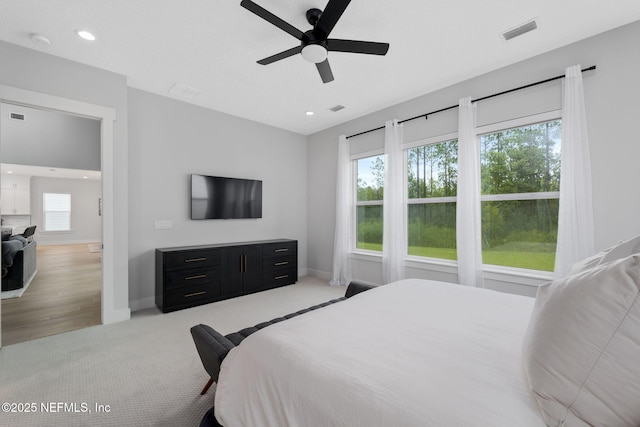 bedroom with light carpet and ceiling fan