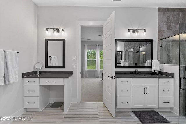 bathroom featuring walk in shower and vanity