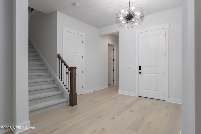 entryway featuring a notable chandelier and light hardwood / wood-style flooring