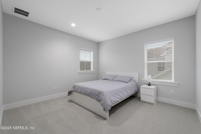 bedroom featuring light colored carpet