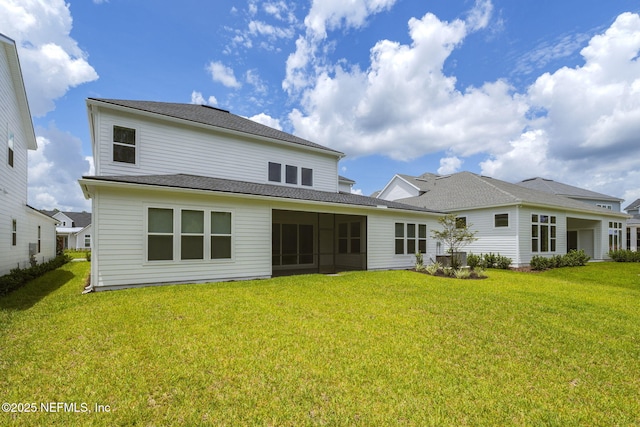 back of house with a lawn