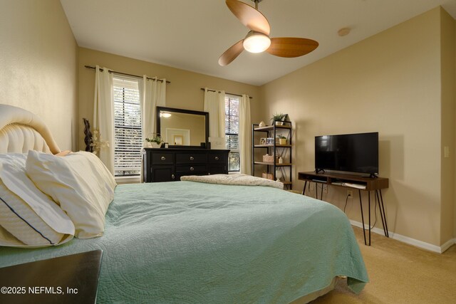 bedroom featuring multiple windows, ceiling fan, and carpet