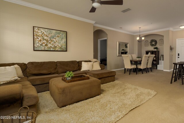 living room with crown molding, carpet, and ceiling fan with notable chandelier