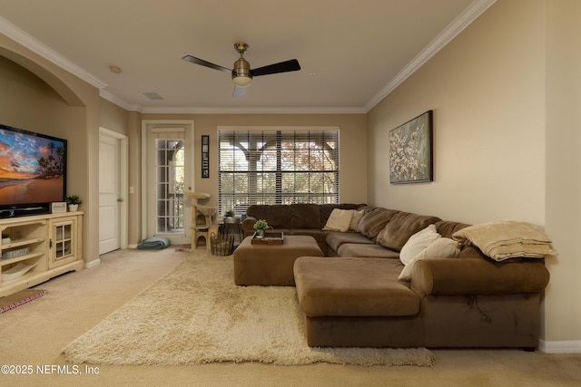 carpeted living room with crown molding and ceiling fan