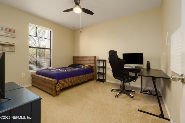 bedroom featuring light colored carpet and ceiling fan