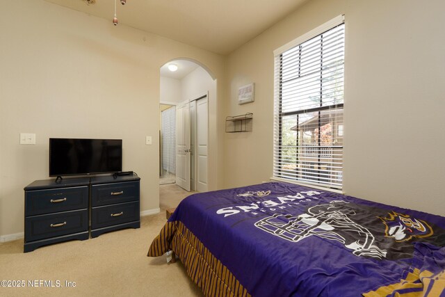 carpeted bedroom with a closet