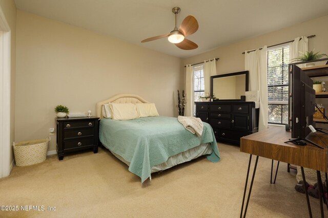 bedroom with ceiling fan and light colored carpet