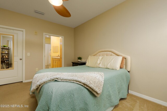 bedroom featuring connected bathroom, ceiling fan, and carpet