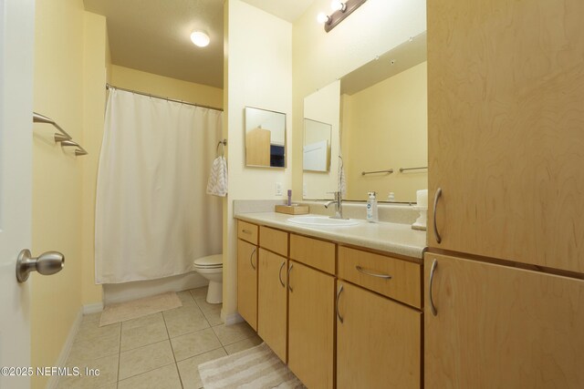 bathroom featuring vanity, tile patterned floors, and toilet