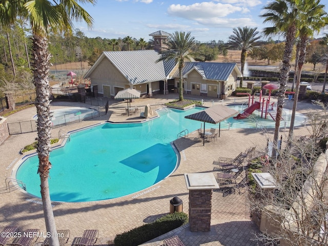 view of swimming pool with a playground and a patio area