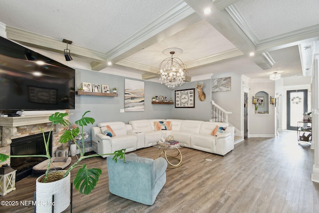 living room featuring a fireplace, coffered ceiling, hardwood / wood-style floors, and beam ceiling