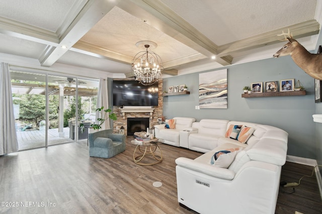 living room with a fireplace, beamed ceiling, hardwood / wood-style flooring, ornamental molding, and coffered ceiling